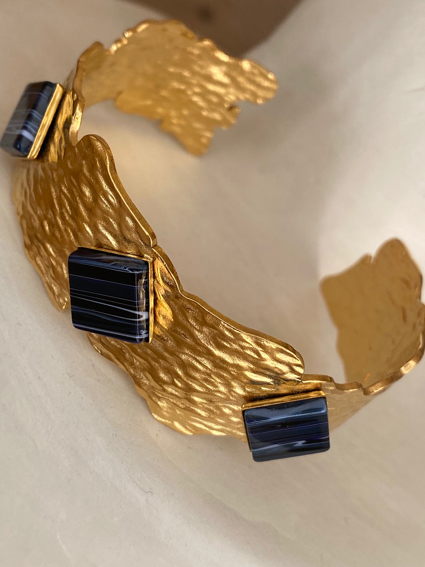 Gold bracelet with black details